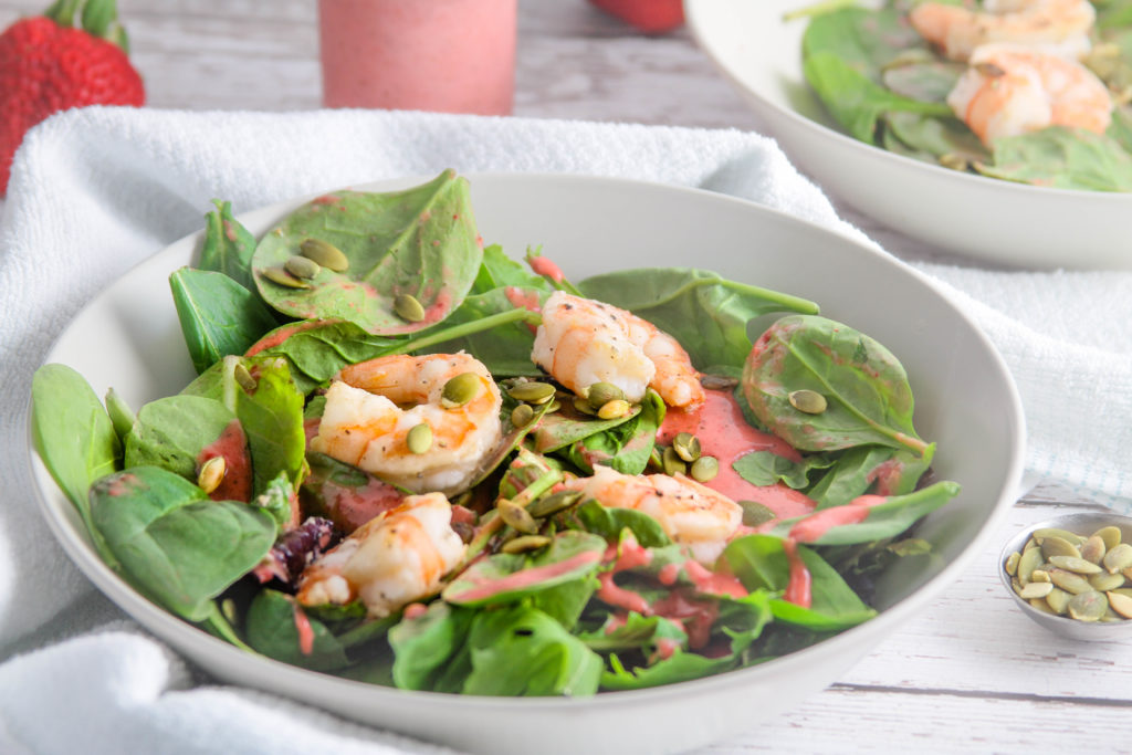 summer shrimp salad with strawberry mint algae oil dressing close-up